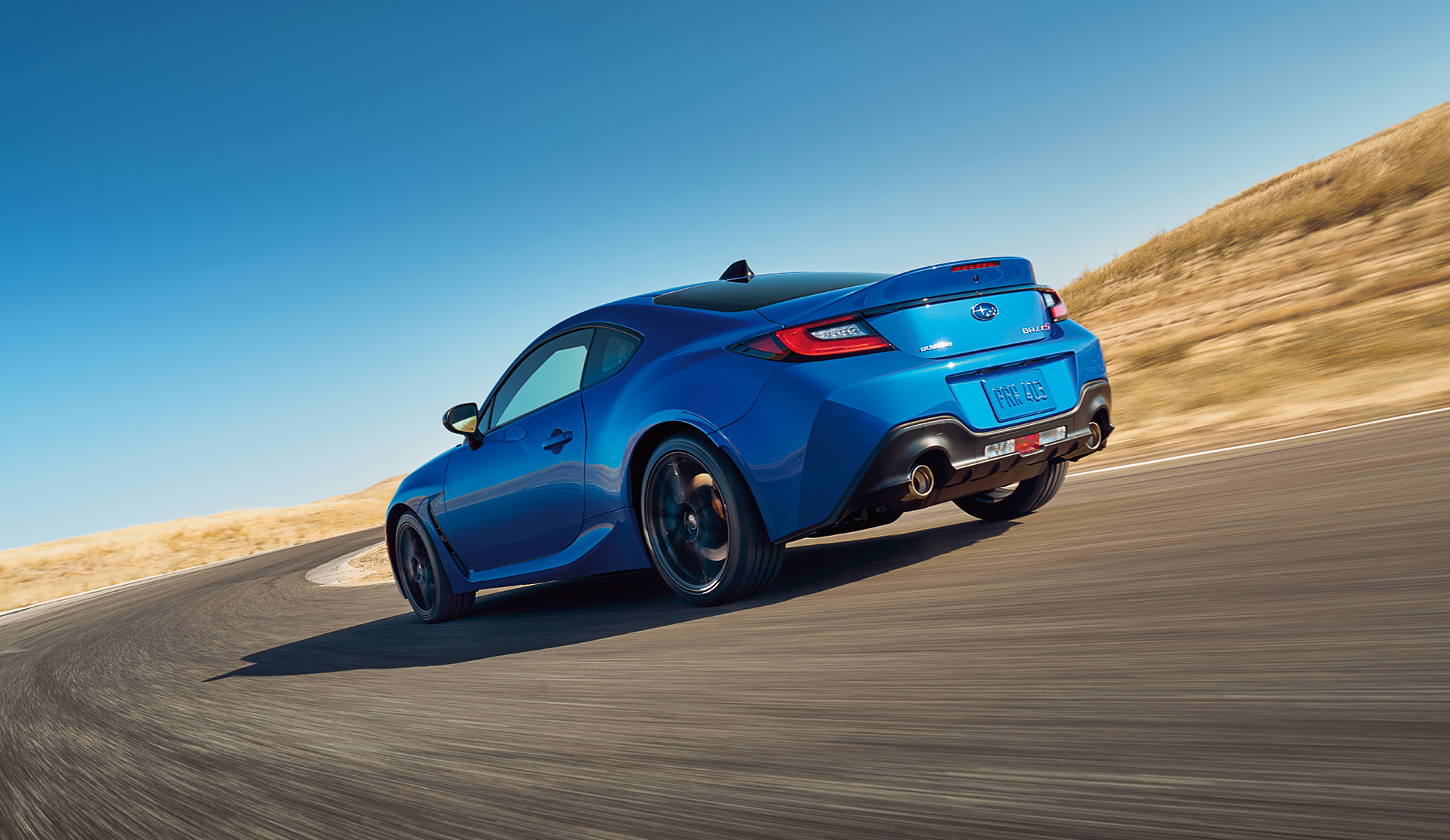 Rear shot of 2025 BRZ tS tackling a corner on racetrack.