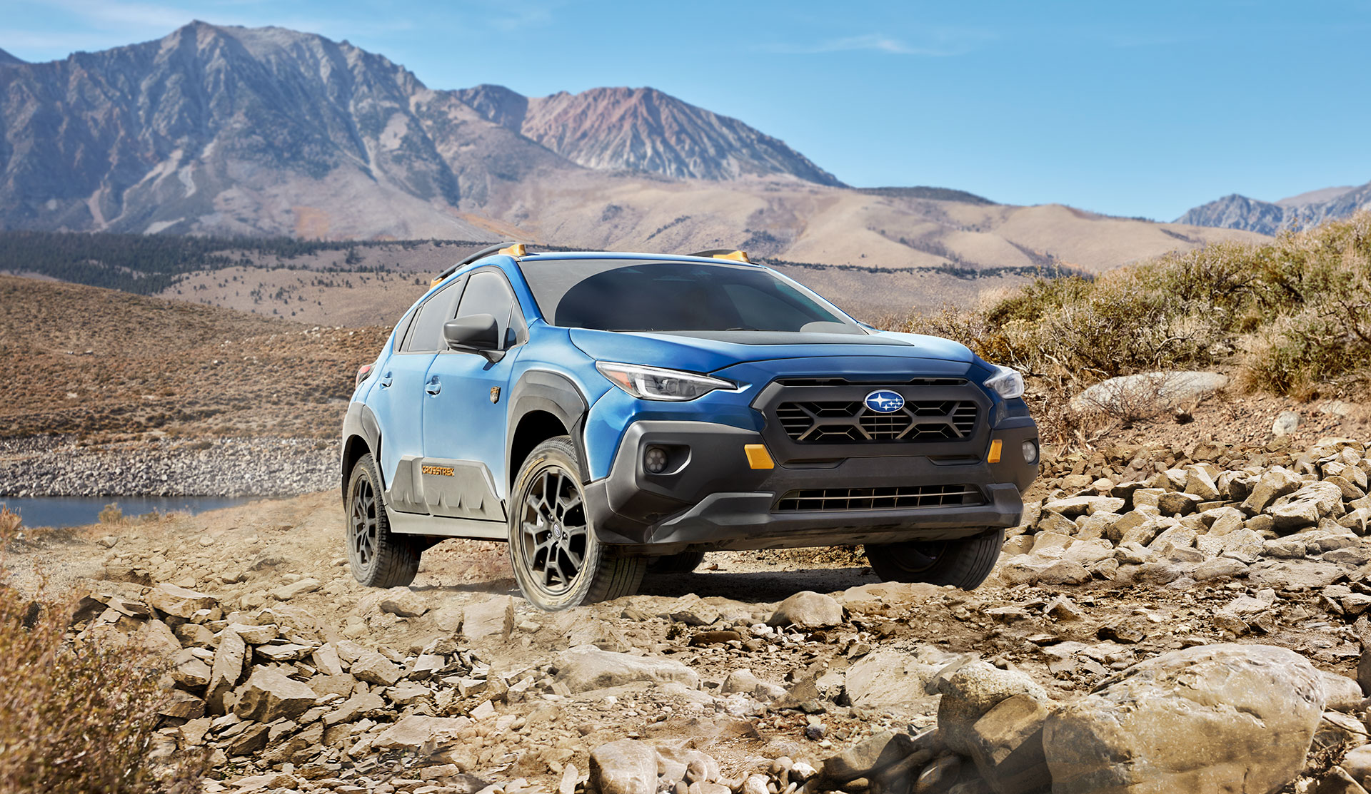 Front shot of 2025 Crosstrek Wilderness stopped on a rocky trail.