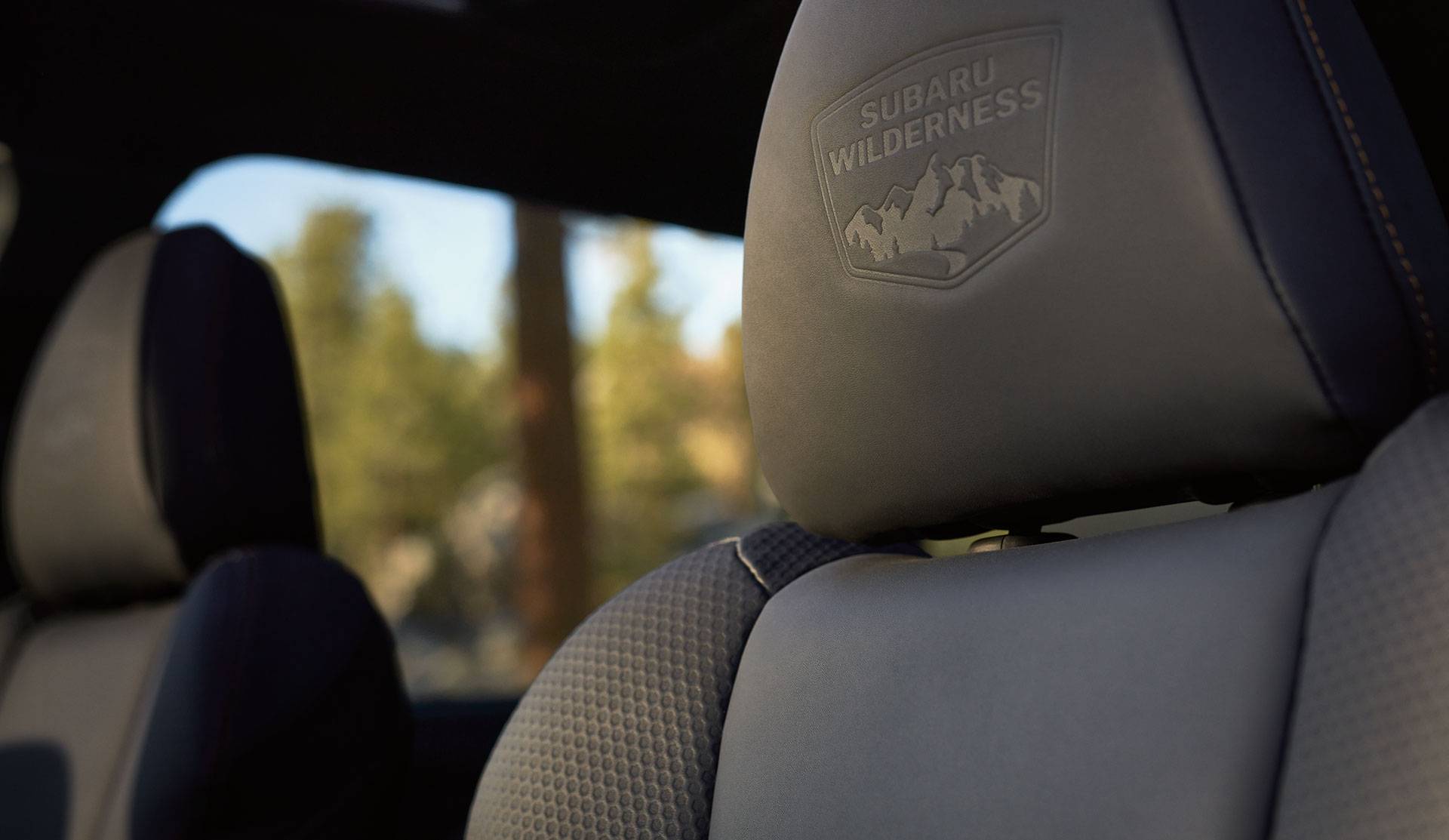 Closeup of the front seat headrest with the Wilderness™ logo embossed in it.