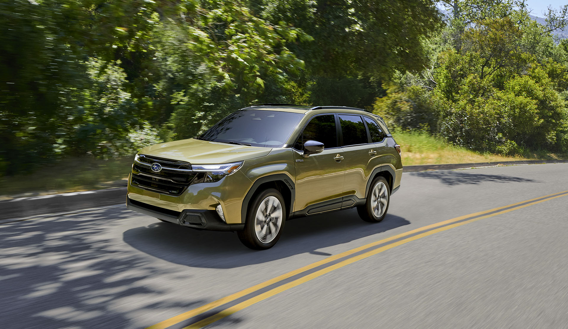 2025 Forester e-BOXER Hybrid driving on suburban road.