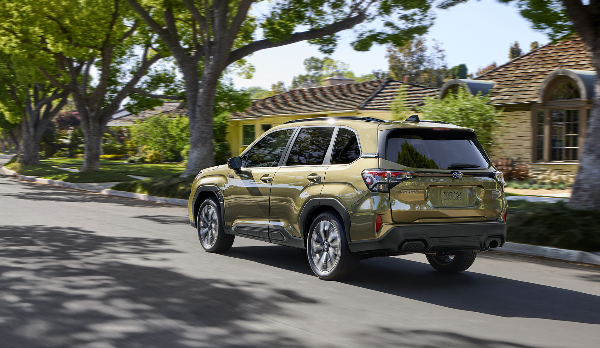 Rear view of the 2025 Forester e-BOXER Hybrid on a town road.